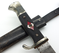 A dagger M 37 for Hitler Youth leaders, with hanger. Maker M7/36, E & F  Hörster, Solingen. Plated blade, the obverse side etched with the motto  Blut und Ehre! (Blood and Honour!). The reverse etched RZM and M7/36.  Silver-plated cross